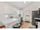 Kitchen with white cabinets, stainless appliances, and an eat-in breakfast area at 890 Knoll Dr., Little River, SC 29566