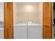 A laundry room with a washer, dryer, wire rack and louvered doors at 890 Knoll Dr., Little River, SC 29566