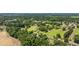 An aerial view showcases a home nestled in a community surrounded by lush greenery and other residences at 903 N Park St. Ext., Mullins, SC 29574