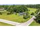 Aerial view of a charming single-story home with a large yard and shed, surrounded by trees and a road at 903 N Park St. Ext., Mullins, SC 29574