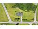 An aerial view of a single-Gathering home with driveway and yard surrounded by lush trees at 903 N Park St. Ext., Mullins, SC 29574