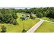 An aerial view shows a quaint single-story home nestled amidst lush greenery and neighboring residences at 903 N Park St. Ext., Mullins, SC 29574