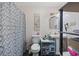 A bathroom featuring a toilet, sink, vanity, mirror, and shower with patterned curtain at 903 N Park St. Ext., Mullins, SC 29574