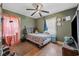 This bedroom has hardwood floors, a ceiling fan, and a cozy atmosphere at 903 N Park St. Ext., Mullins, SC 29574