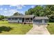 Charming single-story home features a cozy front porch, a well-manicured lawn, and a side driveway at 903 N Park St. Ext., Mullins, SC 29574