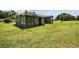 A single-Gathering house with windows and light blue sidings, surrounded by a large grass yard at 903 N Park St. Ext., Mullins, SC 29574