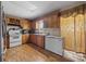 Kitchen featuring oak cabinetry, white appliances, and natural light at 903 N Park St. Ext., Mullins, SC 29574
