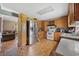 Kitchen features oak cabinetry, stainless steel refrigerator, and wood flooring at 903 N Park St. Ext., Mullins, SC 29574