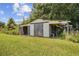 An outbuilding surrounded by grass and vegetation at 903 N Park St. Ext., Mullins, SC 29574
