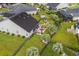 An aerial shot of a backyard featuring a patio, palm trees, and a fire pit for outdoor enjoyment at 908 Ashbourn Ct., Murrells Inlet, SC 29576