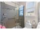 Updated bathroom featuring gray tiles in the glass-enclosed shower, and a window for natural light at 908 Ashbourn Ct., Murrells Inlet, SC 29576