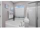 Bright bathroom featuring a soaking tub with jets and a separate glass-enclosed shower with gray paint at 908 Ashbourn Ct., Murrells Inlet, SC 29576