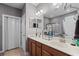 Bathroom featuring double sinks, wood cabinets, framed mirrors, and a glass door shower at 908 Ashbourn Ct., Murrells Inlet, SC 29576