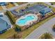 Aerial view of community pool with palm trees, ample parking, and a playground at 908 Ashbourn Ct., Murrells Inlet, SC 29576