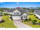 Charming two-story home with a well-manicured lawn, a driveway, and a two-car garage at 908 Ashbourn Ct., Murrells Inlet, SC 29576