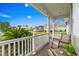 Inviting front porch view with comfortable seating, a white railing, and lush greenery at 908 Ashbourn Ct., Murrells Inlet, SC 29576