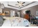 Comfortable main bedroom featuring tray ceilings, soft carpet, and a large wooden bed frame with storage at 908 Ashbourn Ct., Murrells Inlet, SC 29576