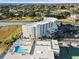 Stunning aerial view of a condo with a pool and golf course, nestled next to a scenic river at 9400 Shore Dr. # 409, Myrtle Beach, SC 29572