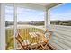 Balcony view with a table and chairs overlooking marshlands and distant buildings at 9400 Shore Dr. # 409, Myrtle Beach, SC 29572