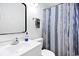 Well-lit bathroom with a single sink vanity, modern fixtures, and a shower with patterned curtains at 9400 Shore Dr. # 409, Myrtle Beach, SC 29572