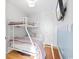 Cozy bedroom with bunk beds, wood floors, a wall-mounted TV, and painted with an ocean design at 9400 Shore Dr. # 409, Myrtle Beach, SC 29572