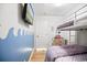 Charming bedroom featuring a bunk bed, TV, and unique ocean wave wall art at 9400 Shore Dr. # 409, Myrtle Beach, SC 29572