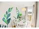 Cozy dining area with unique leaf wall art and seating for six beside the balcony window at 9400 Shore Dr. # 409, Myrtle Beach, SC 29572