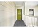 Inviting green front door with white railing provides private entrance to condo unit at 9400 Shore Dr. # 409, Myrtle Beach, SC 29572