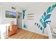 Cozy living room with a wall mural, flat-screen TV, a decorative dresser, and view of the hallway at 9400 Shore Dr. # 409, Myrtle Beach, SC 29572