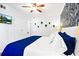 Bright bedroom featuring a king bed, tropical wallpaper, wall-mounted TV, and a double door closet at 9400 Shore Dr. # 409, Myrtle Beach, SC 29572