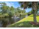 Beautiful view of a lush backyard, pond, and fountain in a residential neighborhood at 946 Wyndfall Dr., Sunset Beach, NC 28468