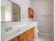 Well-lit bathroom with a wood vanity, a framed mirror, and a shower with glass doors at 946 Wyndfall Dr., Sunset Beach, NC 28468
