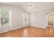 Empty bedroom showcasing wood floors, vaulted ceilings, and multiple windows with natural light at 946 Wyndfall Dr., Sunset Beach, NC 28468