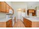 Kitchen featuring white appliances, a view of the dining area, and wood cabinets at 946 Wyndfall Dr., Sunset Beach, NC 28468