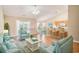 Staged living room with seating, wood floors, and a view into the kitchen at 946 Wyndfall Dr., Sunset Beach, NC 28468