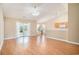 Open-concept living room featuring vaulted ceilings, wood floors, and sliding glass doors to the backyard at 946 Wyndfall Dr., Sunset Beach, NC 28468
