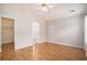 Primary bedroom showcasing wood floors, neutral walls, and an ensuite bathroom entrance at 946 Wyndfall Dr., Sunset Beach, NC 28468
