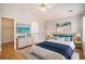 Staged primary bedroom with wood floors, a king bed, dresser, and modern decorations at 946 Wyndfall Dr., Sunset Beach, NC 28468