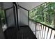 Private balcony with black metal railing, wooden floor and siding overlooking trees at 950 Forestbrook Rd. # B-8, Myrtle Beach, SC 29588