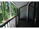 Private balcony with black metal railing, wooden floor and sliding door to the interior at 950 Forestbrook Rd. # B-8, Myrtle Beach, SC 29588