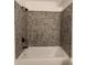 This bathroom features a white tub and neutral tile at 950 Forestbrook Rd. # B-8, Myrtle Beach, SC 29588