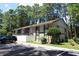 Two-story townhome with black and white exterior, mature trees and ample parking at 950 Forestbrook Rd. # B-8, Myrtle Beach, SC 29588