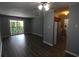 Living room featuring wood flooring, ceiling fan, balcony, and view to kitchen at 950 Forestbrook Rd. # B-8, Myrtle Beach, SC 29588