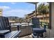Relaxing balcony featuring comfortable seating and a view of the surrounding buildings and palm trees at 9501 Shore Dr. # 135, Myrtle Beach, SC 29572
