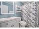 Bathroom featuring a shower, toilet, sink, mirror, and open shelf for storage at 9501 Shore Dr. # 135, Myrtle Beach, SC 29572