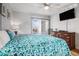 Bright bedroom featuring a queen bed with floral bedding, dresser, and ceiling fan at 9501 Shore Dr. # 135, Myrtle Beach, SC 29572