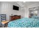 Spacious bedroom featuring a queen bed with floral bedding and a large flat screen tv at 9501 Shore Dr. # 135, Myrtle Beach, SC 29572