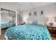 Well-lit bedroom featuring a queen bed with floral bedding and a mirrored closet at 9501 Shore Dr. # 135, Myrtle Beach, SC 29572