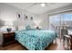 Bright bedroom featuring a queen bed with floral bedding and access to the balcony at 9501 Shore Dr. # 135, Myrtle Beach, SC 29572