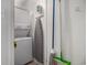 Functional laundry area with stacked washer and dryer, ironing board and cleaning supplies at 9501 Shore Dr. # 135, Myrtle Beach, SC 29572